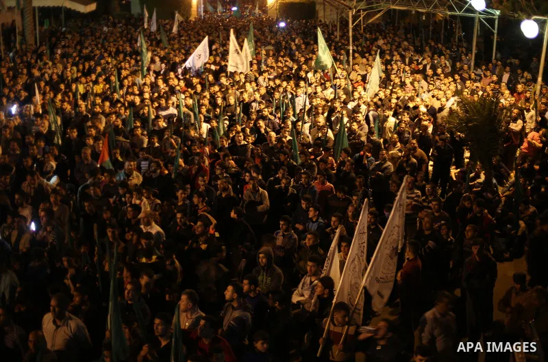 Supporters of the Palestinian Hamas movement hold banners during a protest against Palestinian President Mahmoud Abbas and Israeli blockade of the Gaza Strip, in Gaza city, on April 29, 2017. Photo by Mohammed Asad