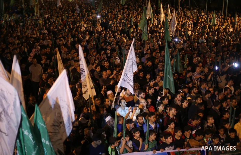 Supporters of the Palestinian Hamas movement hold banners during a protest against Palestinian President Mahmoud Abbas and Israeli blockade of the Gaza Strip, in Gaza city, on April 29, 2017. Photo by Mohammed Asad