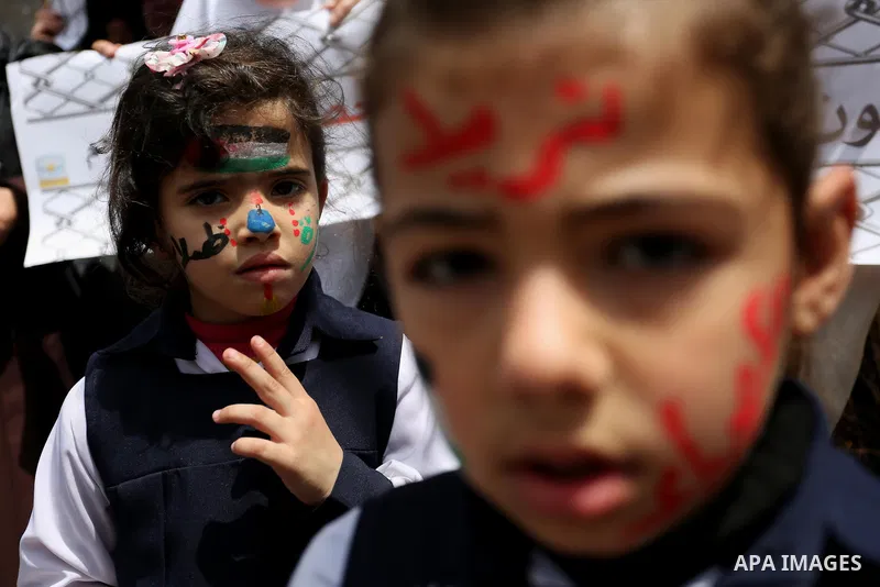 Palestinian children hold banners during a protest to demand the end of Israeli blockade of the Gaza Strip and against the worsening crisis of power outages in Gaza City, in Gaza city on April 30, 2017. Photo by Ashraf A...