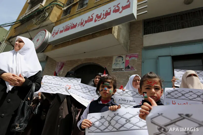 Palestinian children hold banners during a protest to demand the end of Israeli blockade of the Gaza Strip and against the worsening crisis of power outages in Gaza City, in Gaza city on April 30, 2017. Photo by Ashraf A...