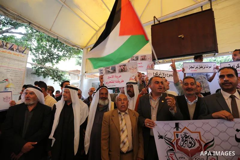 Palestinians take part in a protest to show solidarity with Palestinian prisoners on hunger strike in Israeli jails, in front of Red cross office in Gaza city on May 1, 2017. As more than 1,000 Palestinian prisoners ente...
