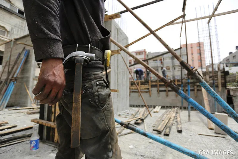 Palestinian laborers construction work at building still under construction to mark May Day or International Workers' Day, in Gaza city on May 01. 2017. Photo by Ashraf Amra