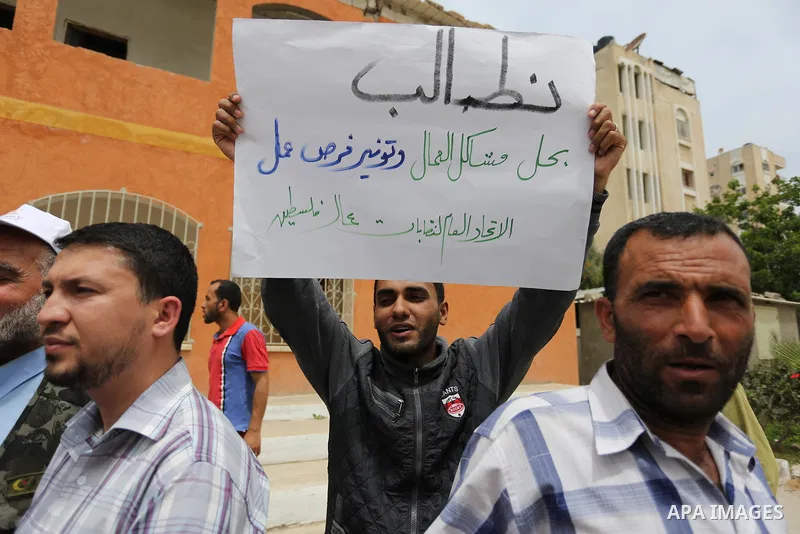 Palestinian workers take part in a protest demanding better working conditions, more jobs and higher wages to mark May Day or International Workers' Day, in Gaza city on May 01. 2017. Photo by Ashraf Amra