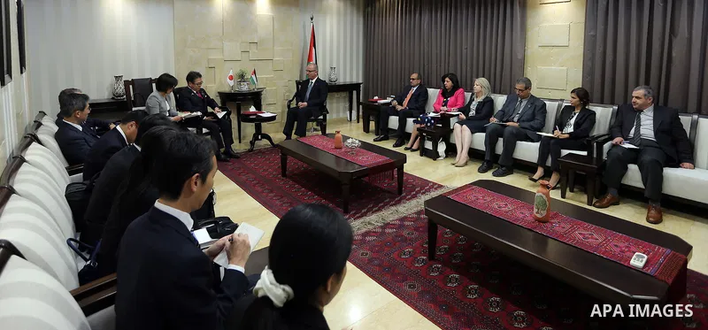 Palestinian Prime Minister Rami Hamdallah meets with Japanese State Minister of Economy, Trade and Industry Hiroshige Seko in the West Bank city of Ramallah on May 02, 2017. Photo by Prime Minister Office