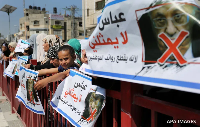 Palestinians hold a poster depicting Palestinian President Mahmoud Abbas during a protest against the blockade in Dair Al Balah, in the center of Gaza strip on May 2, 2017 demanding an end to the one-decade-old Israeli s...