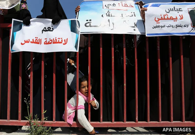 Palestinians hold a poster depicting Palestinian President Mahmoud Abbas during a protest against the blockade in Dair Al Balah, in the center of Gaza strip on May 2, 2017 demanding an end to the one-decade-old Israeli s...