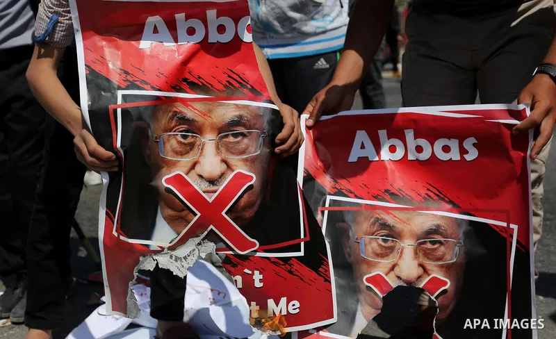 Palestinians hold a poster depicting Palestinian President Mahmoud Abbas during a protest against the blockade in Dair Al Balah, in the center of Gaza strip on May 2, 2017 demanding an end to the one-decade-old Israeli s...