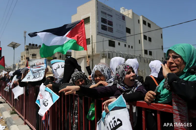 Palestinians hold a poster depicting Palestinian President Mahmoud Abbas during a protest against the blockade in Dair Al Balah, in the center of Gaza strip on May 2, 2017 demanding an end to the one-decade-old Israeli s...