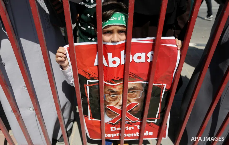 Palestinians hold a poster depicting Palestinian President Mahmoud Abbas during a protest against the blockade in Dair Al Balah, in the center of Gaza strip on May 2, 2017 demanding an end to the one-decade-old Israeli s...