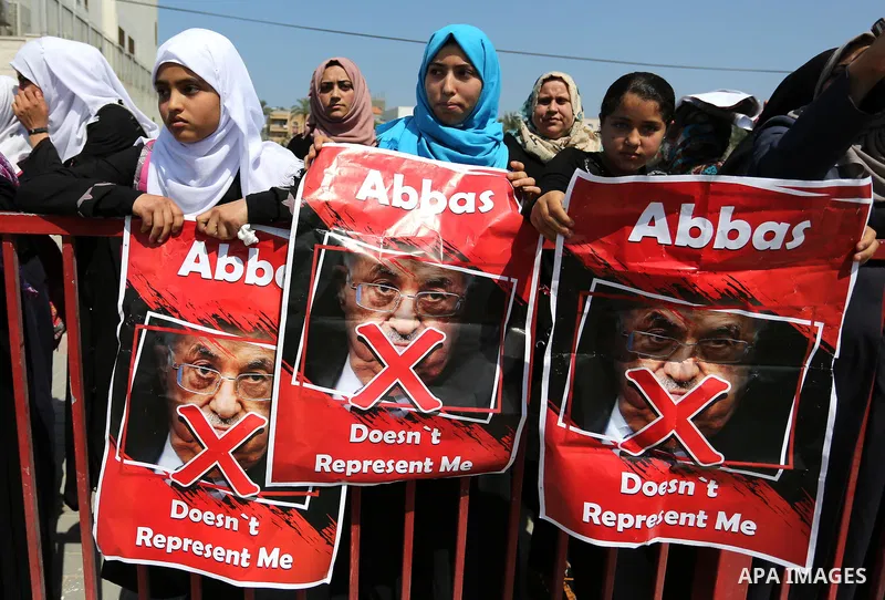 Palestinians hold a poster depicting Palestinian President Mahmoud Abbas during a protest against the blockade in Dair Al Balah, in the center of Gaza strip on May 2, 2017 demanding an end to the one-decade-old Israeli s...
