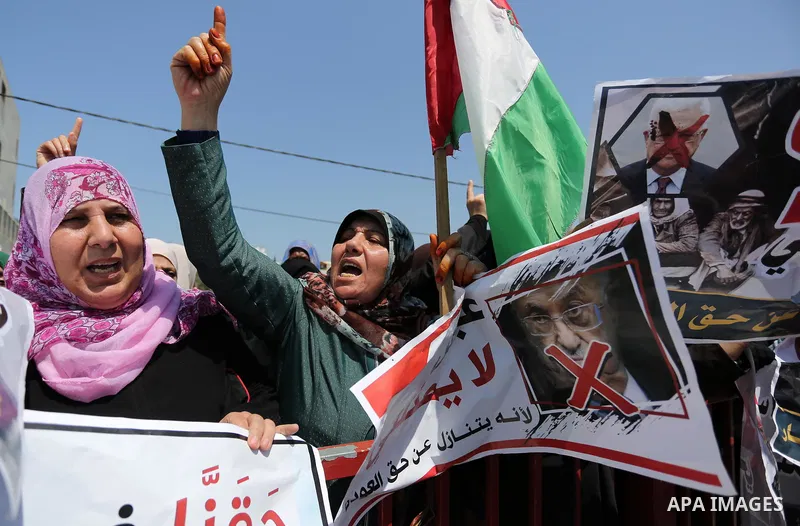 Palestinians hold a poster depicting Palestinian President Mahmoud Abbas during a protest against the blockade in Dair Al Balah, in the center of Gaza strip on May 2, 2017 demanding an end to the one-decade-old Israeli s...