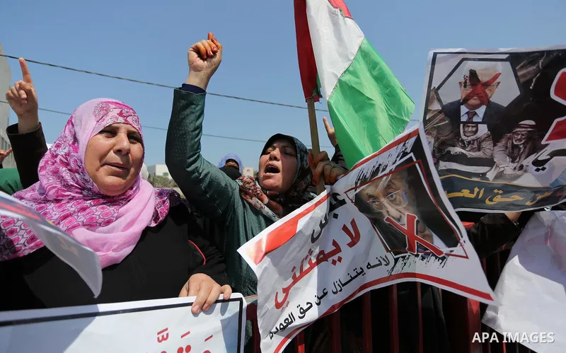 Palestinians hold a poster depicting Palestinian President Mahmoud Abbas during a protest against the blockade in Dair Al Balah, in the center of Gaza strip on May 2, 2017 demanding an end to the one-decade-old Israeli s...