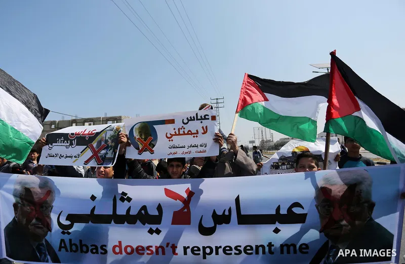 Palestinians hold a poster depicting Palestinian President Mahmoud Abbas during a protest against the blockade in Dair Al Balah, in the center of Gaza strip on May 2, 2017 demanding an end to the one-decade-old Israeli s...