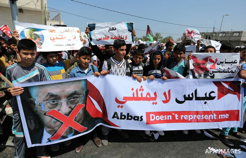 Palestinians hold a poster depicting Palestinian President Mahmoud Abbas during a protest against the blockade in Dair Al Balah, in the center of Gaza strip on May 2, 2017 demanding an end to the one-decade-old Israeli s...