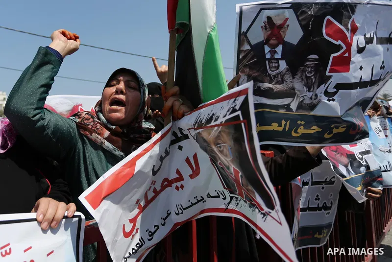 Palestinians hold a poster depicting Palestinian President Mahmoud Abbas during a protest against the blockade in Dair Al Balah, in the center of Gaza strip on May 2, 2017 demanding an end to the one-decade-old Israeli s...