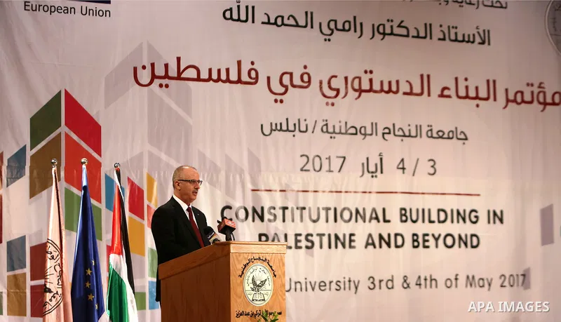 Palestinian Prime Minister Rami Hamdallah speaks during the conference of constitutional building in Palestine and beyond, at An-Najah national University in the West Bank city of Nablus on May 03, 2017. Photo by Prime M...