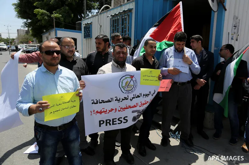 Palestinian Journalists hold banners during a protest calling for stop the Israeli violence against journalists on the occasion of World Press Freedom day in front of the high commissioner for human rights headquarters,...