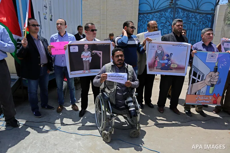 Palestinian Journalists hold banners during a protest calling for stop the Israeli violence against journalists on the occasion of World Press Freedom day in front of the high commissioner for human rights headquarters,...