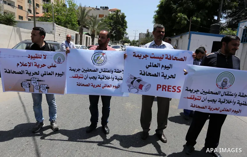 Palestinian Journalists hold banners during a protest calling for stop the Israeli violence against journalists on the occasion of World Press Freedom day in front of the high commissioner for human rights headquarters,...