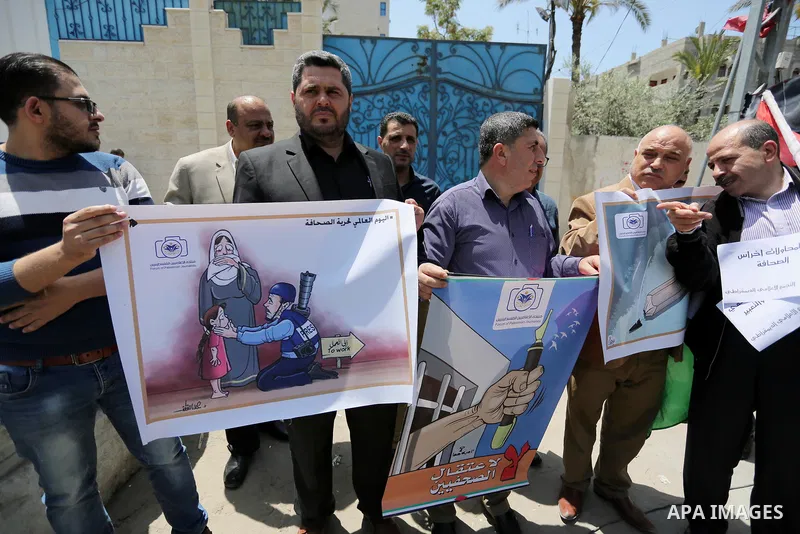 Palestinian Journalists hold banners during a protest calling for stop the Israeli violence against journalists on the occasion of World Press Freedom day in front of the high commissioner for human rights headquarters,...