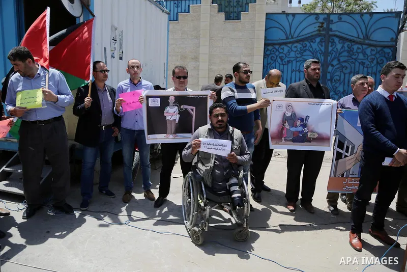 Palestinian Journalists hold banners during a protest calling for stop the Israeli violence against journalists on the occasion of World Press Freedom day in front of the high commissioner for human rights headquarters,...