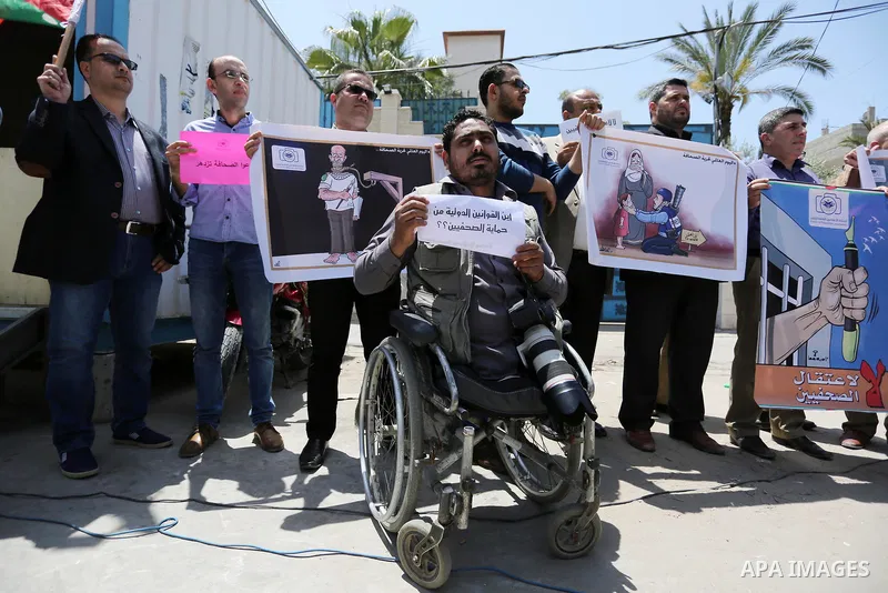 Palestinian Journalists hold banners during a protest calling for stop the Israeli violence against journalists on the occasion of World Press Freedom day in front of the high commissioner for human rights headquarters,...