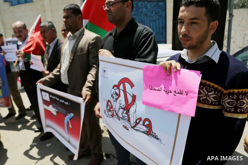 Palestinian Journalists hold banners during a protest calling for stop the Israeli violence against journalists on the occasion of World Press Freedom day in front of the high commissioner for human rights headquarters,...
