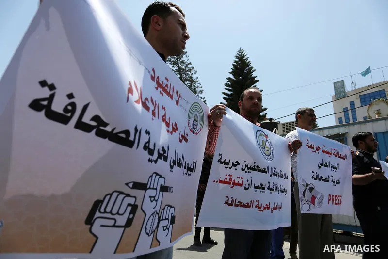 Palestinian Journalists hold banners during a protest calling for stop the Israeli violence against journalists on the occasion of World Press Freedom day in front of the high commissioner for human rights headquarters,...