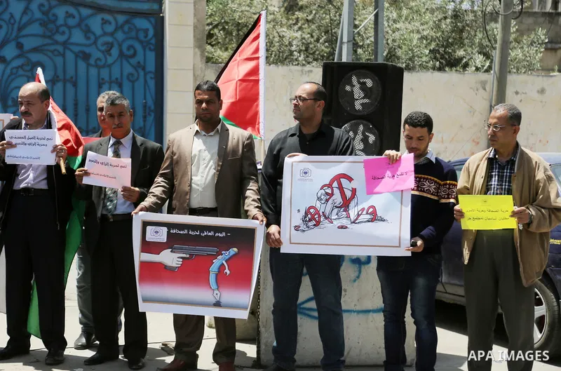 Palestinian Journalists hold banners during a protest calling for stop the Israeli violence against journalists on the occasion of World Press Freedom day in front of the high commissioner for human rights headquarters,...