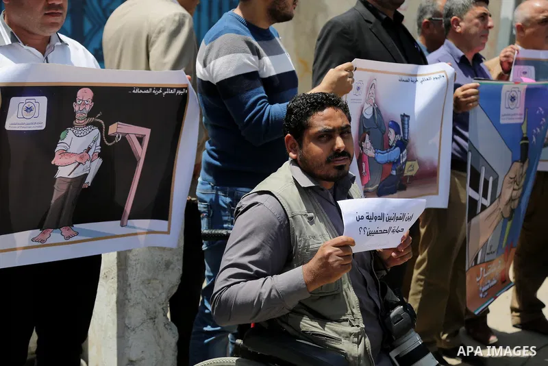 Palestinian Journalists hold banners during a protest calling for stop the Israeli violence against journalists on the occasion of World Press Freedom day in front of the high commissioner for human rights headquarters,...