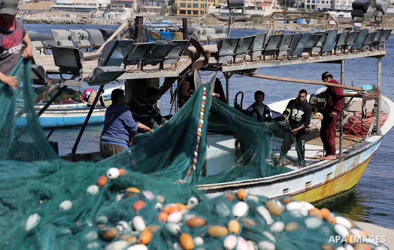 Palestinian fishermen pull their net at the beach of Gaza City, on May 03, 2017. Israel has eased restrictions on Gaza fishermen, allowing them to travel up to nine nautical miles off the coast of the blockaded territory...