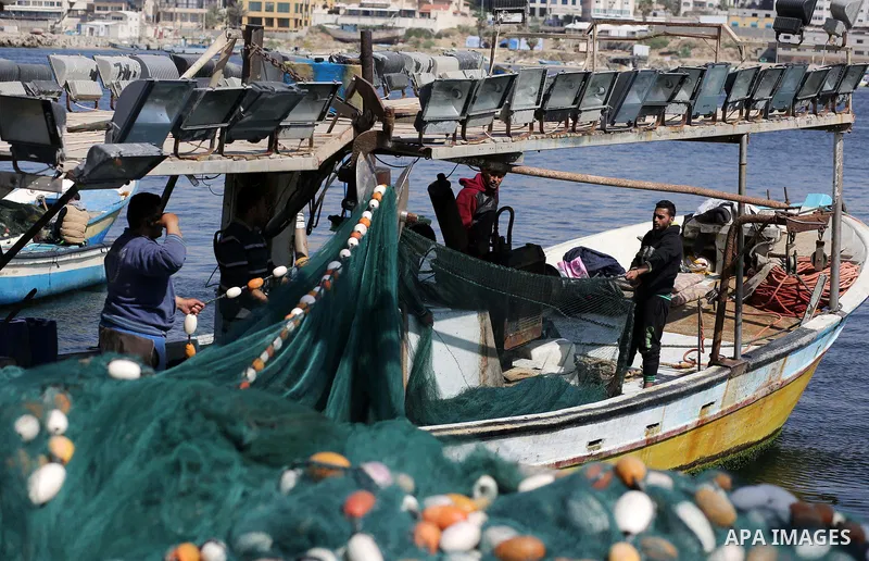 Palestinian fishermen pull their net at the beach of Gaza City, on May 03, 2017. Israel has eased restrictions on Gaza fishermen, allowing them to travel up to nine nautical miles off the coast of the blockaded territory...