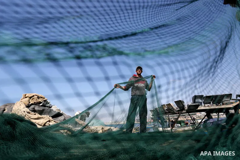 Palestinian fishermen pull their net at the beach of Gaza City, on May 03, 2017. Israel has eased restrictions on Gaza fishermen, allowing them to travel up to nine nautical miles off the coast of the blockaded territory...