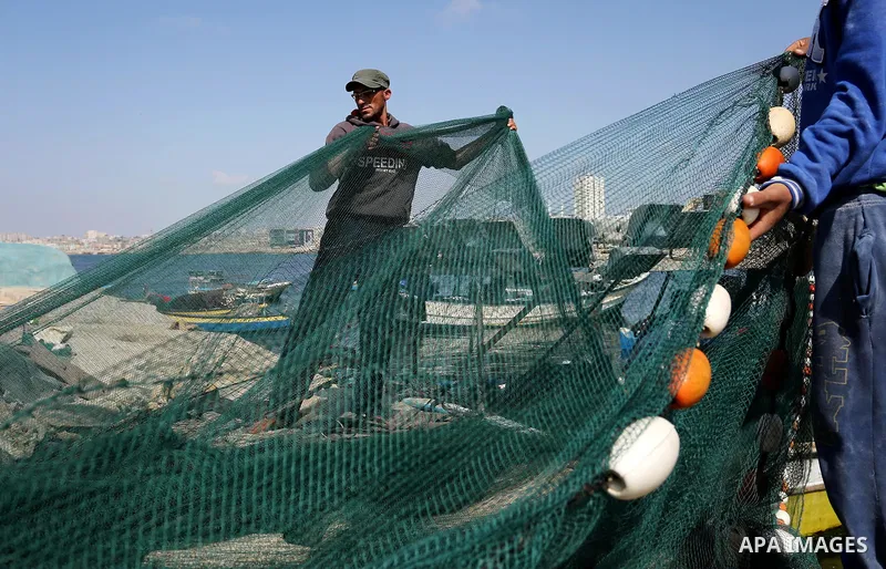 Palestinian fishermen pull their net at the beach of Gaza City, on May 03, 2017. Israel has eased restrictions on Gaza fishermen, allowing them to travel up to nine nautical miles off the coast of the blockaded territory...