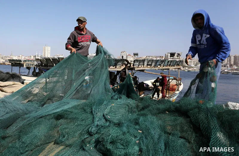 Palestinian fishermen pull their net at the beach of Gaza City, on May 03, 2017. Israel has eased restrictions on Gaza fishermen, allowing them to travel up to nine nautical miles off the coast of the blockaded territory...