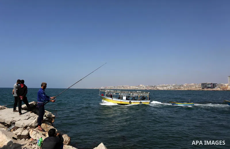 A Palestinian man uses a hook to fishing at the beach of Gaza City, on May 03, 2017. Israel has eased restrictions on Gaza fishermen, allowing them to travel up to nine nautical miles off the coast of the blockaded terri...