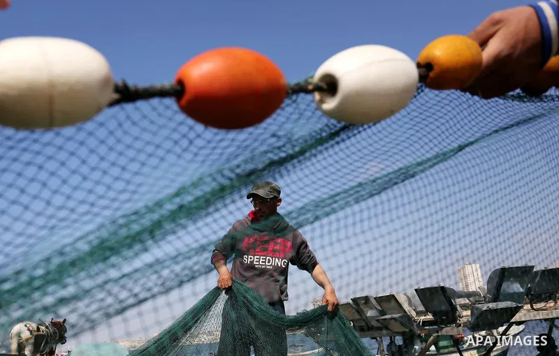 Palestinian fishermen pull their net at the beach of Gaza City, on May 03, 2017. Israel has eased restrictions on Gaza fishermen, allowing them to travel up to nine nautical miles off the coast of the blockaded territory...