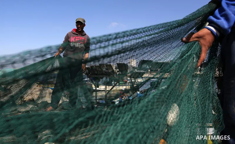 Palestinian fishermen pull their net at the beach of Gaza City, on May 03, 2017. Israel has eased restrictions on Gaza fishermen, allowing them to travel up to nine nautical miles off the coast of the blockaded territory...