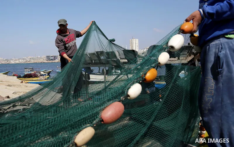 Palestinian fishermen pull their net at the beach of Gaza City, on May 03, 2017. Israel has eased restrictions on Gaza fishermen, allowing them to travel up to nine nautical miles off the coast of the blockaded territory...