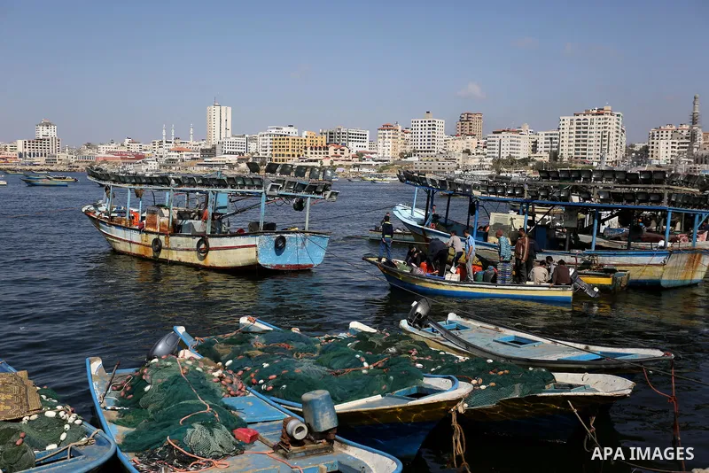 Palestinian fishermen work on their fishing boat at the beach of Gaza City, on May 03, 2017. Israel has eased restrictions on Gaza fishermen, allowing them to travel up to nine nautical miles off the coast of the blockad...