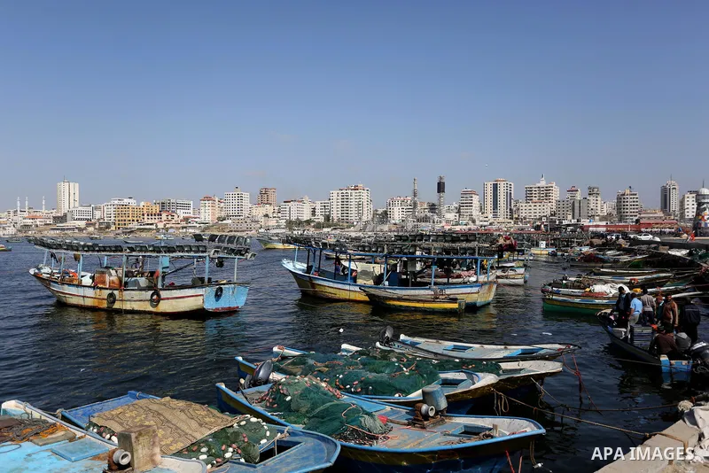 Palestinian fishermen work on their fishing boat at the beach of Gaza City, on May 03, 2017. Israel has eased restrictions on Gaza fishermen, allowing them to travel up to nine nautical miles off the coast of the blockad...