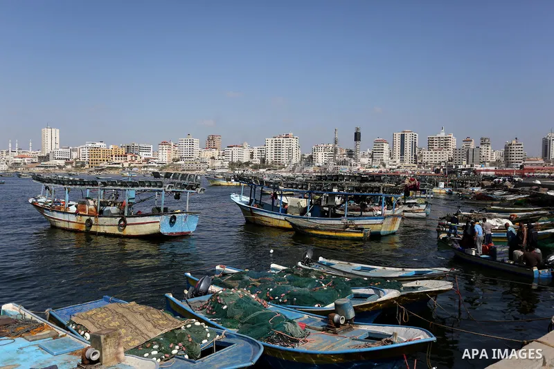 Palestinian fishermen work on their fishing boat at the beach of Gaza City, on May 03, 2017. Israel has eased restrictions on Gaza fishermen, allowing them to travel up to nine nautical miles off the coast of the blockad...