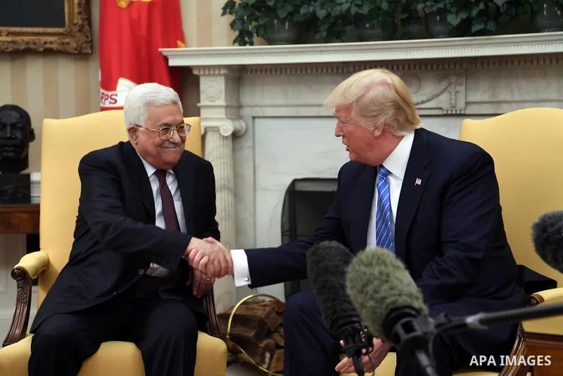 US President Donald Trump shakes hands with Palestinian President Mahmoud Abbas during a meeting in the Oval Office of the White House on May 3, 2017 in Washington, DC. Photo by Thaer Ganaim