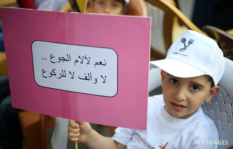 Palestinian children take part in a protest to show solidarity with Palestinian prisoners on hunger strike in Israeli jails, in the West Bank city of Nablus, on May 4, 2017. Photo by Ayman Ameen