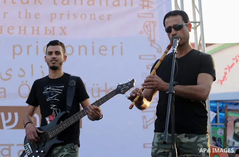 Musicians perform during a concert held in solidarity with Palestinian hunger-striking prisoners in Israeli jails, in Gaza City on May 4, 2017. Photo by Mohammed Asad