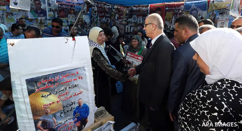 Palestinian Prime Minister Rami Hamdallah takes part at a protest tent in solidarity with Palestinian hunger-striking prisoners in Israeli jails, in the West Bank city of Ramallah on May 4, 2017. Photo by Prime Minister...
