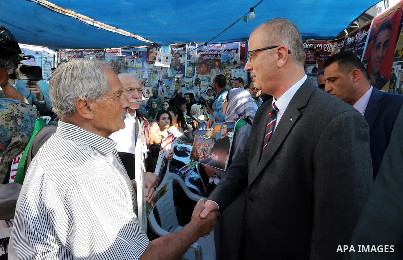 Palestinian Prime Minister Rami Hamdallah takes part at a protest tent in solidarity with Palestinian hunger-striking prisoners in Israeli jails, in the West Bank city of Ramallah on May 4, 2017. Photo by Prime Minister...