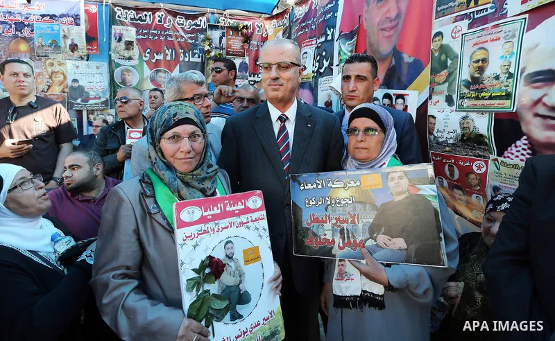 Palestinian Prime Minister Rami Hamdallah takes part at a protest tent in solidarity with Palestinian hunger-striking prisoners in Israeli jails, in the West Bank city of Ramallah on May 4, 2017. Photo by Prime Minister...