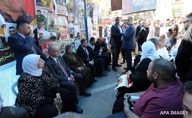 Palestinian Prime Minister Rami Hamdallah takes part at a protest tent in solidarity with Palestinian hunger-striking prisoners in Israeli jails, in the West Bank city of Ramallah on May 4, 2017. Photo by Prime Minister...