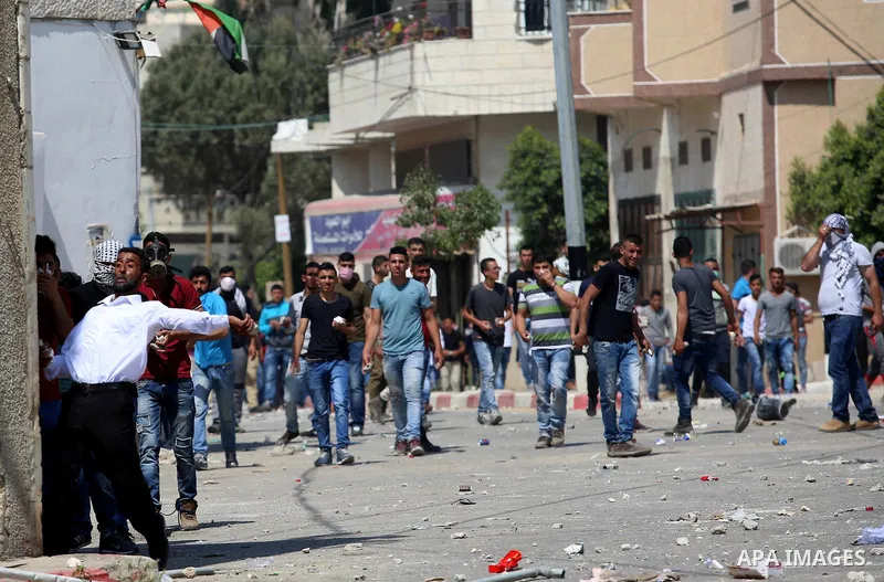 Palestinian protesters hurl stones towards Israeli security forces during clashes at a protest in support of Palestinian prisoners on hunger strike in Israeli jails, in the West Bank village of Beita, near Nablus May 5,...